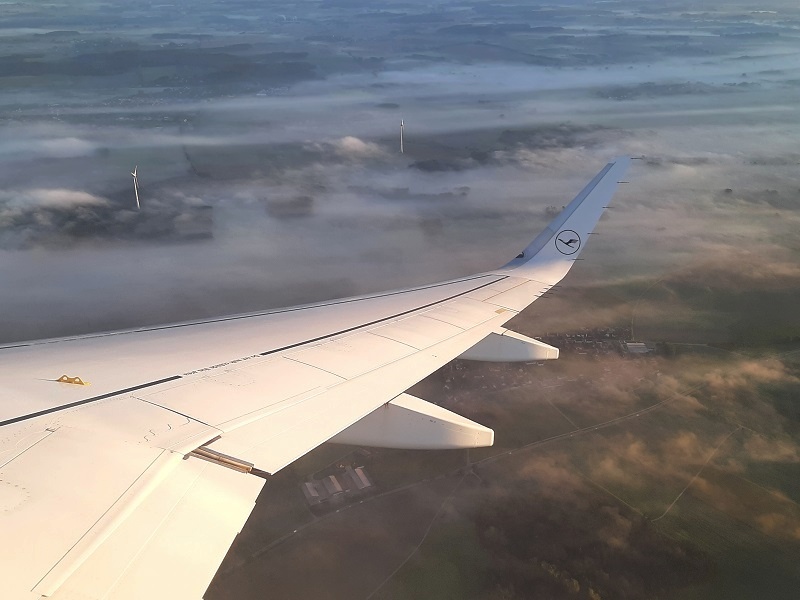 wind turbines piercing fog lufthansa airbus a320-neo economy class